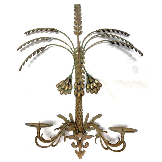 Pretty vintage two candle wall sconce in the Hollywood Regency style from the mid 20th century. It is made of brass and...