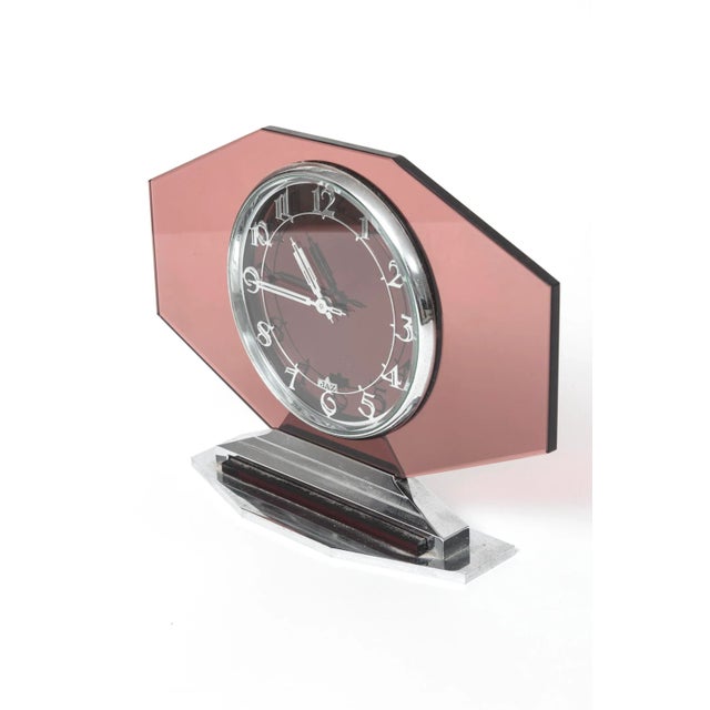 Art Deco French pink glass 'Jaz' 8-day clock. Pink glass with silver numerals and hands and metal base & top. Face has JAZ...
