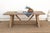 The Chablis runs on the same pegged tavern trestle as its siblings, two angled sawhorse ends joined by a full stretcher...