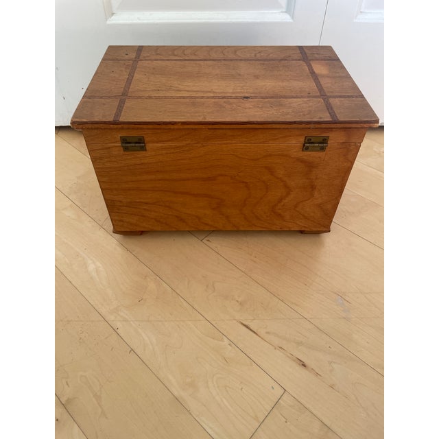 This vintage small table top chest trunk wooden box with inlay trim is a handcrafted antique piece made of wood. It...