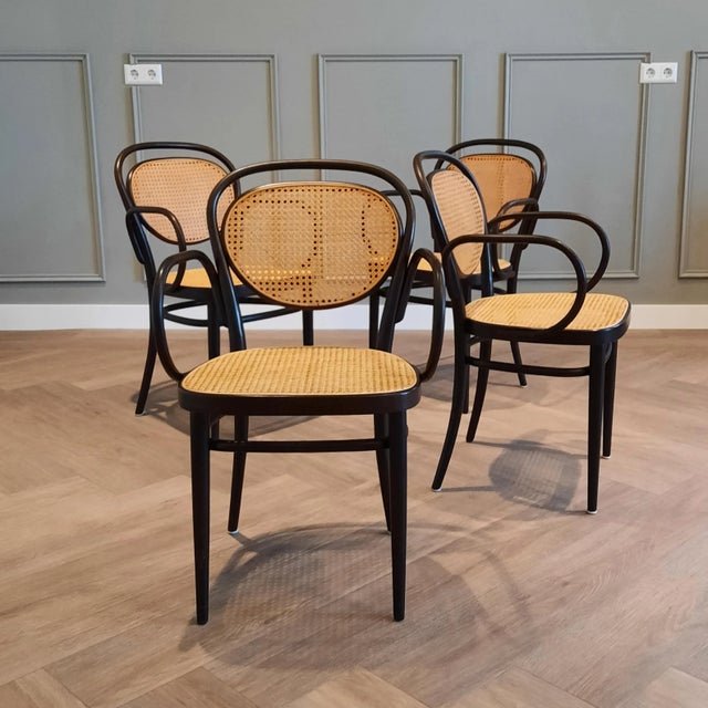 This set of 4 Thonet no. 215 RF (coffee house) chairs was manufactured 1980 (as marked underneath the seat). The chair was...