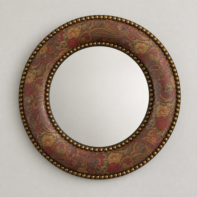 A distinctive late 20th century round wall mirror featuring a richly patterned paisley-covered frame accented with rows of...