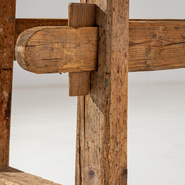 A vintage Central European wooden work table. Constructed from stout wooden beams, crafted with the owner’s livelihood in...