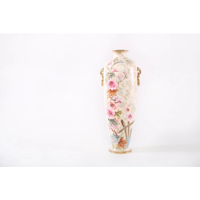 19th century very tall gilt porcelain decorative vase / piece with exterior floral design details . The vase / piece is in...