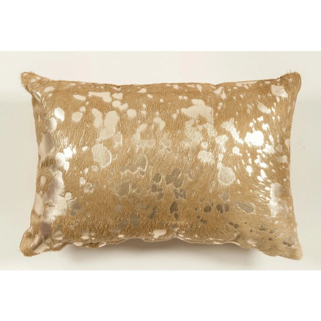 Metalic Brazilian Cowhide, Gold Silky Velvet back, Fiber insert This pillow is made using unique cowhides, with no two...