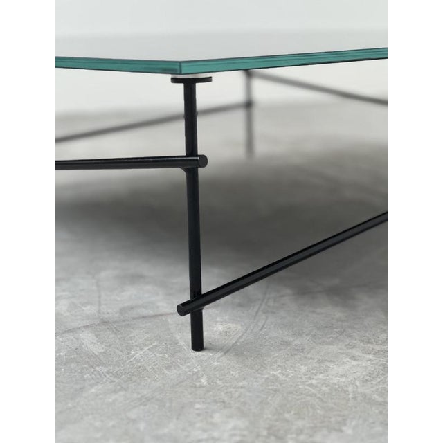 A striking minimalist coffee table that perfectly balances industrial elegance with modern restraint. Featuring a sleek...