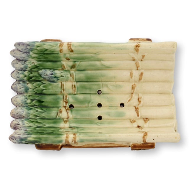 Late 19th century French majolica asparagus cradle with richly modeled asparagus spears resting on an openwork stand...