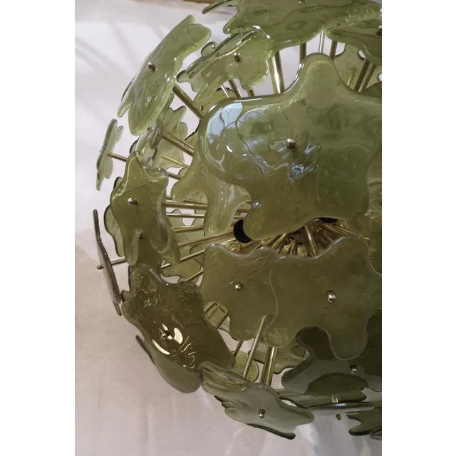 A fantastic spot of green color, amazing design due to its very particular shape of these green glass flowers and for the...