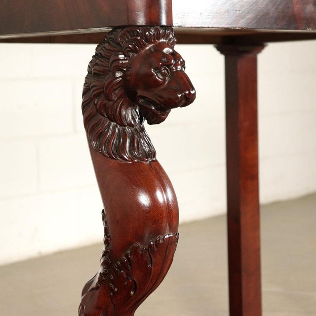 Elegant console supported by wavy front legs finely carved with lion face and feline paws lean on a mixtilineal base. Band...