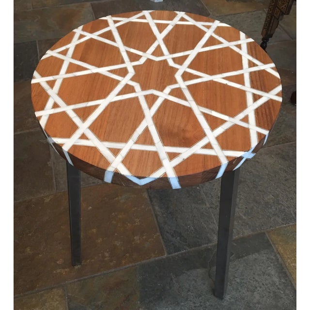 The wood is natural walnut wood, unstained wood color inlaid with natural mother of pearl and silver metallic wire around....