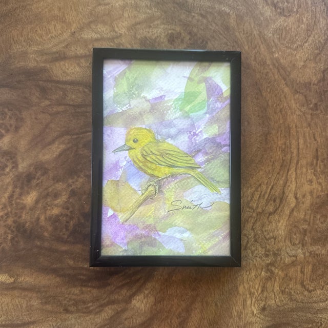 This delicate scene features a yellow warbler perched against an abstract backdrop of purples and greens, evoking a...