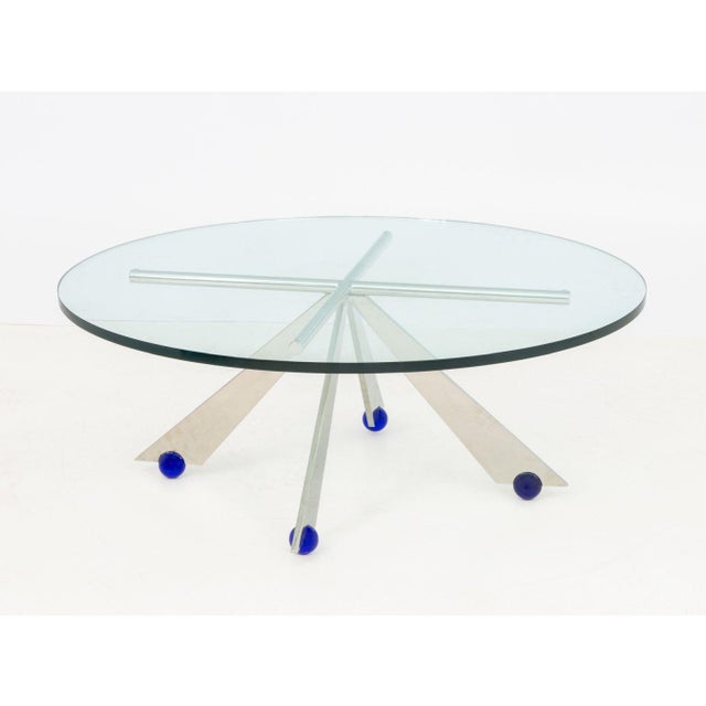 Postmodern Circular Glass Top and Chrome-Plated Coffee Table, the geometric base on four cobalt blue glass ball feet. 16"...