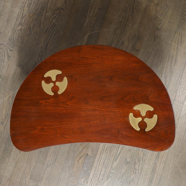 This Mid-Century Modernist bow-front table, designed by the celebrated American furniture maker Mastercraft circa 1970, is...