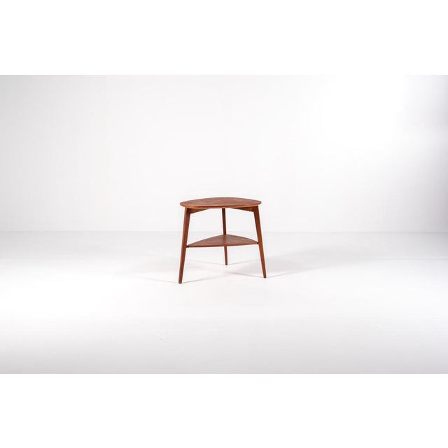Elegant Danish modern side table designed by Jørgen Aakjær Jørgensen for Møbelintarsia in the 1960s. Crafted in teak, the...