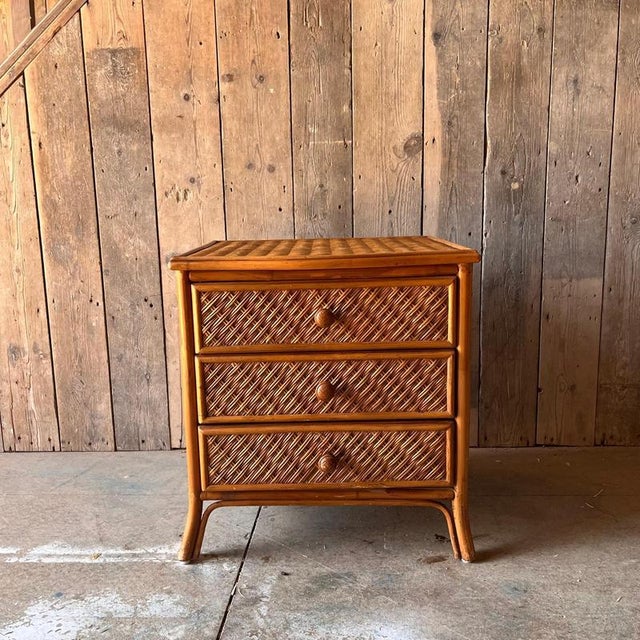 Vintage Wicker Bedside table with 3 drawers Wicker covers the top and sides and front Wooden handles with detailing...