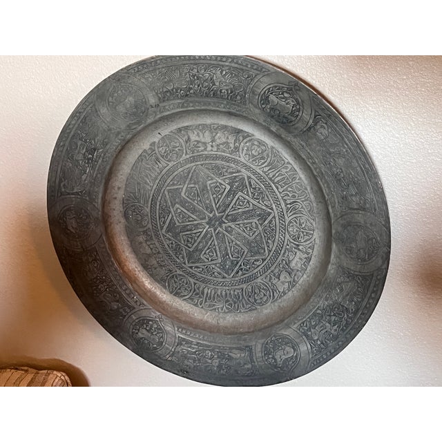 Late 19th century hand-engraved Islamic metal plate or charger, likely made from tinned copper or a white-metal alloyr. It...