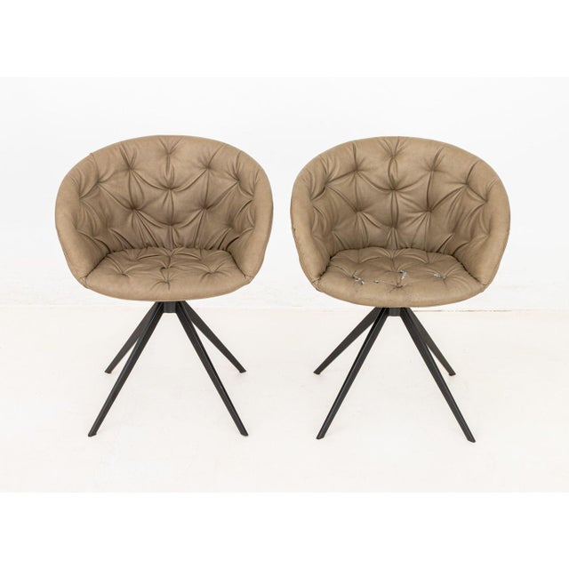 Pair of La Seggiola "Cabiria 4G" Chairs, each with four blackened metal legs above tufted dove grey vinyl upholstered seat...