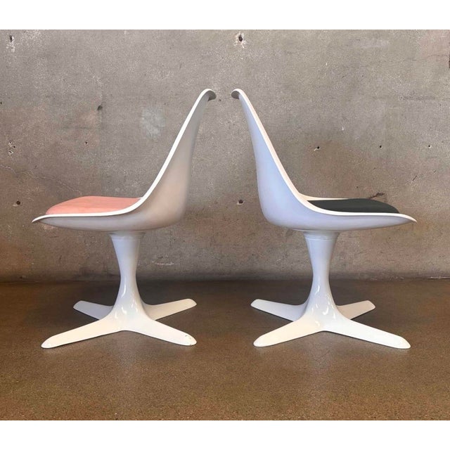 These are a pair of authentic Burke molded fiberglass chairs and a matching round pedestal table, all beautifully...