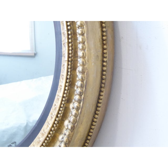 This 19th century convex mirror with original glass mirror measures 35"Diameter x 5"D.
