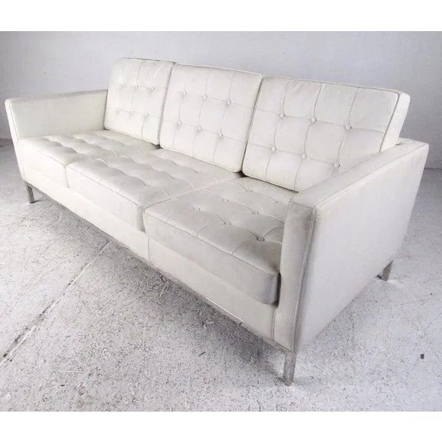 This three-seat modern sofa features chrome finish frame with tufted vinyl upholstery. Distinctive sofa in the style of...
