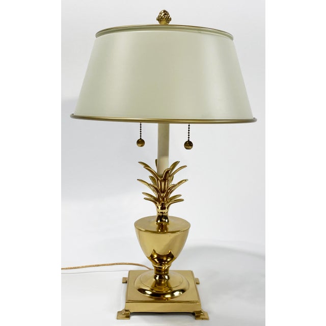 Vintage brass pineapple lamp with ivory metal tole shade. Lamp has double sockets with separate brass pulls for each bulb....