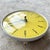 Vintage small yellow Westclox wall clock. Original pull cord mechanism which allows you to wind the clock without removing...