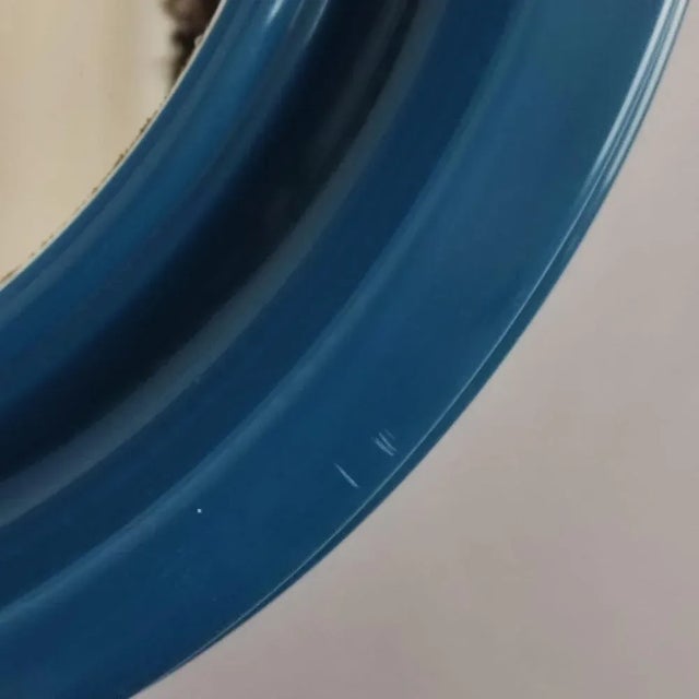 Mirror with a typical 70s design. Colored plastic frame in blue with original round mirror. Excellent overall vintage...