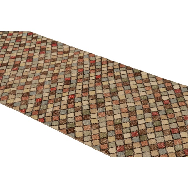 This vintage runner rug is a 3x9 Turkish distressed piece, made with hand-knotted wool circa mid-20th century. It is an...