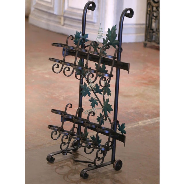 Crafted in the Rhone region of France circa 2000, the cart is forged of iron and decorated with green painted metal vine...