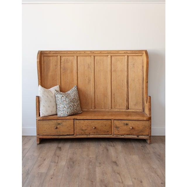 This slightly curved antique pine bench dates to the late 1700s to early 1800s and is a fine example of traditional...