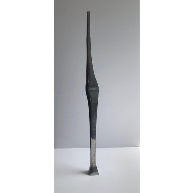 A suite of 2 sculptures. Lovers, man and woman nestled together. sleek minimalist mod sculpture. polished finish on one...