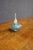 Late 20th-century studio art glass perfume bottle with a rounded, flattened form and elongated frosted glass stopper. The...