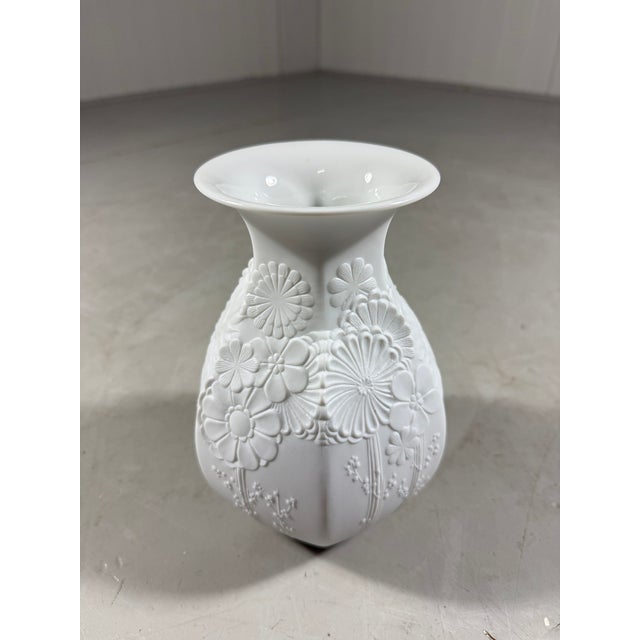 Lovely vase by AK Kaiser, Germany (signed). White bisque porcelain with stylized flower relief. 1960’s. In very good...