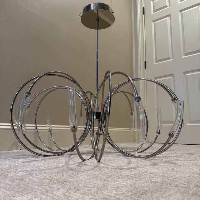 The Terzani Hook Chandelier Pendant Light is a modern and stylish addition to any living room. With a sleek nickel...
