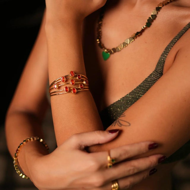 The Cleopatra Gold & Carnelian Stone Cuff Chunky Bracelet features a stunning design with 24k gold plating, composed of...