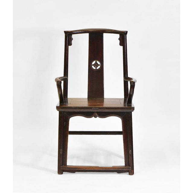 An antique Chinese open hardwood armchair. Circa 1880. The chair shows good patina and age related wear to the finish. An...
