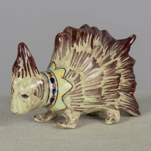 A late 19th century French Blois faience whimsical porcupine figurine. Hand-painted with greenish yellow body and brown...