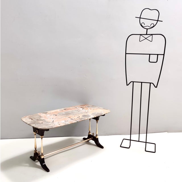 Made in Italy, 1960s. This coffee table features a turned beech frame with brass and varnished metal details, and a...