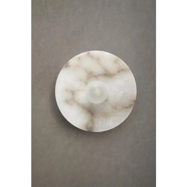Alba simple wall xl alabaster light by contain dimensions: ø 22 x h9.5 cm materials: alabaster structure and optical lens....