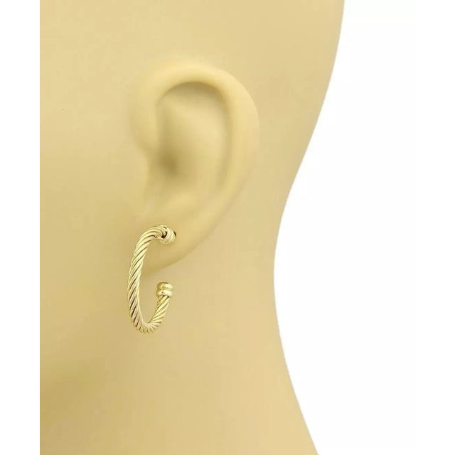 Simple elegance from Charriol, this pretty pair of hoop earrings are crafted from solid 18k yellow gold with a fine...
