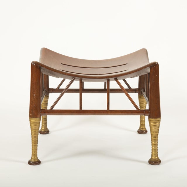 A stylish 20th century interpretation of the classic Egyptian Thebes stool, featuring a gently curved, saddle-shaped...