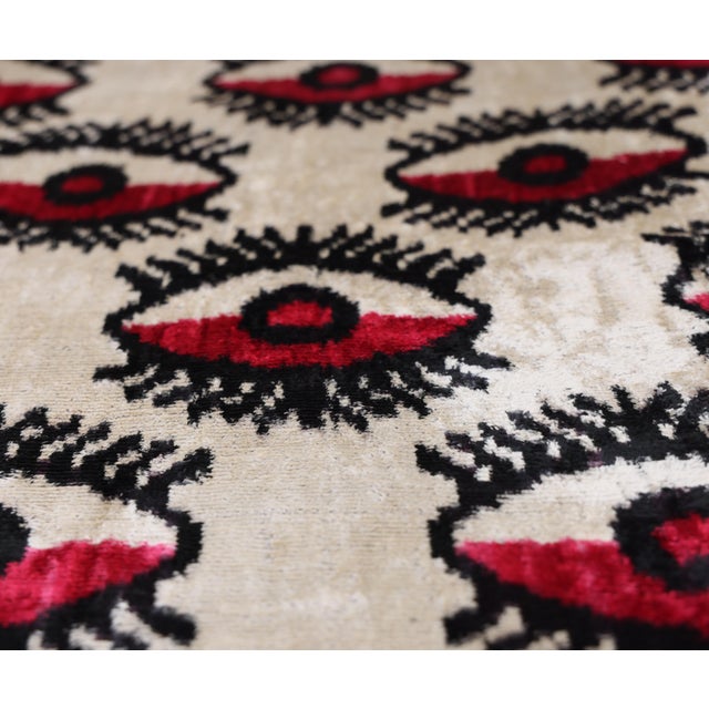 "Channel protective energy and artisanal mastery with this striking hand-knotted silk velvet ikat lumbar pillow. Measuring...