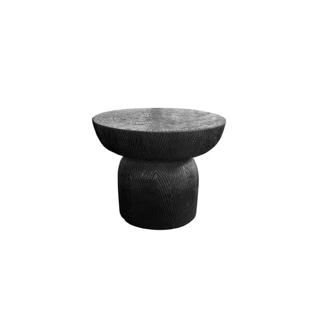 This sculptural side table is finished in a deep, burnt black tone, achieved through a meticulous multi-stage burning...