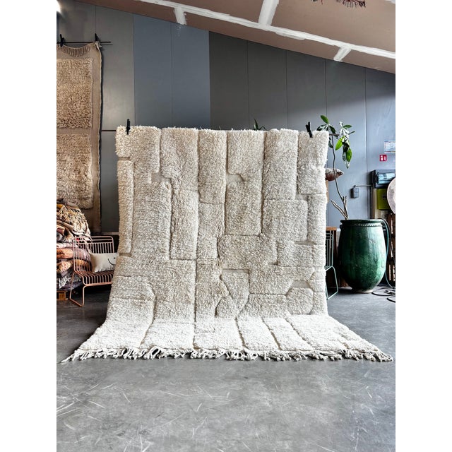 This Moroccan Mrirt Beni Ouarain rug is a handwoven piece created by skilled artisans from the Middle Atlas region of...