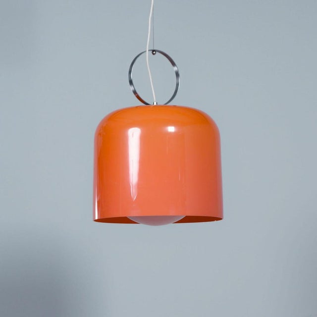 Alvise guzzini pendant lamp by luigi massoni from the early 1970s, made of orange acrylic glass with an integrated white...