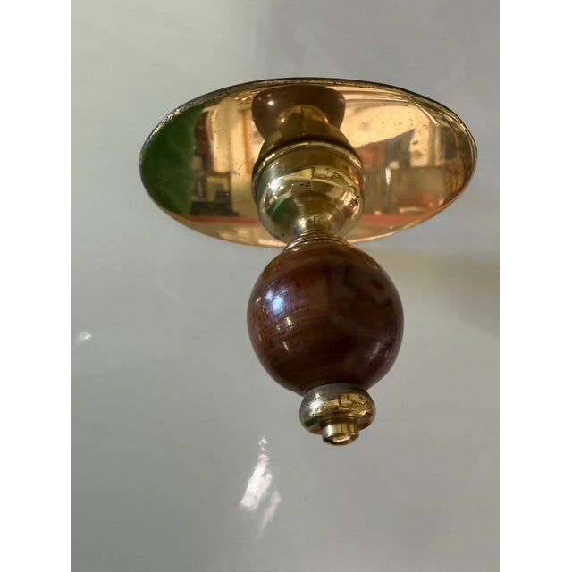 Elegant set of 10 brown sphere-shaped coat hangers in turned brass and lucite, designed in the 1950s by Luigi Caccia...