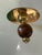 Elegant set of 10 brown sphere-shaped coat hangers in turned brass and lucite, designed in the 1950s by Luigi Caccia...
