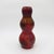 A dark red antique vase of triple gourd shape enveloped in a metallic lustreware glaze with areas of iridescence, creating...