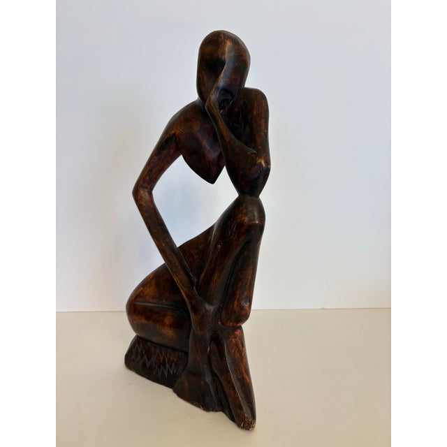 This "Thinking man" is a beautiful piece of hand-carved mahogany which is from Ghana as indicated by the marking on the...