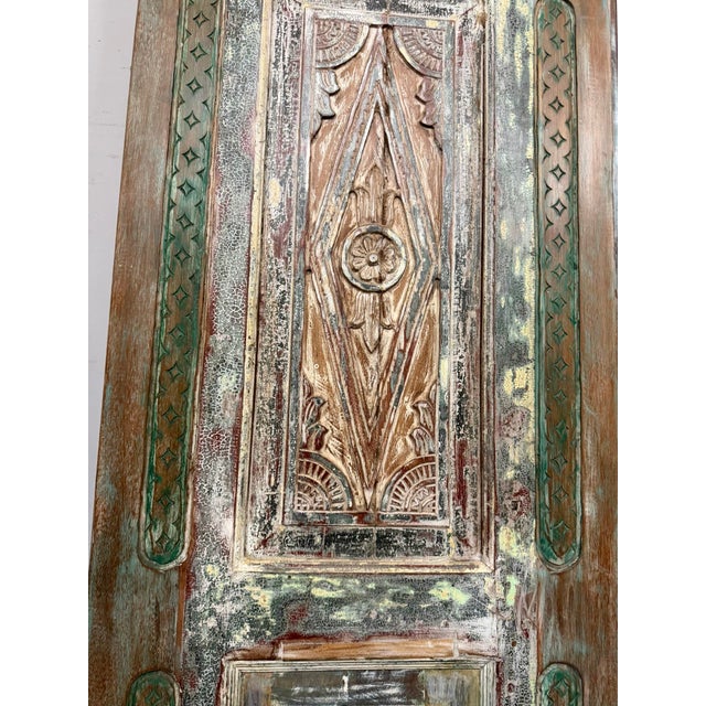 A stunning piece of architectural history, this antique wood door panel features intricate hand-carved detailing that...